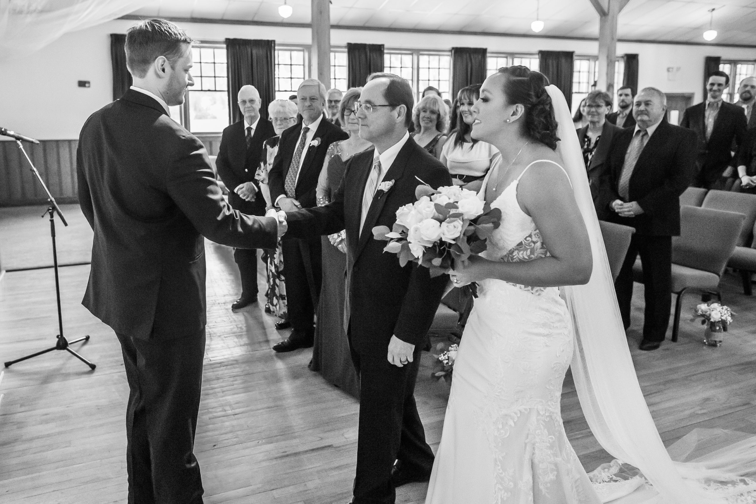 The bride processes in with her father to greet the groom during a YMCA of the Rockies wedding in Estes Park, Colorado.