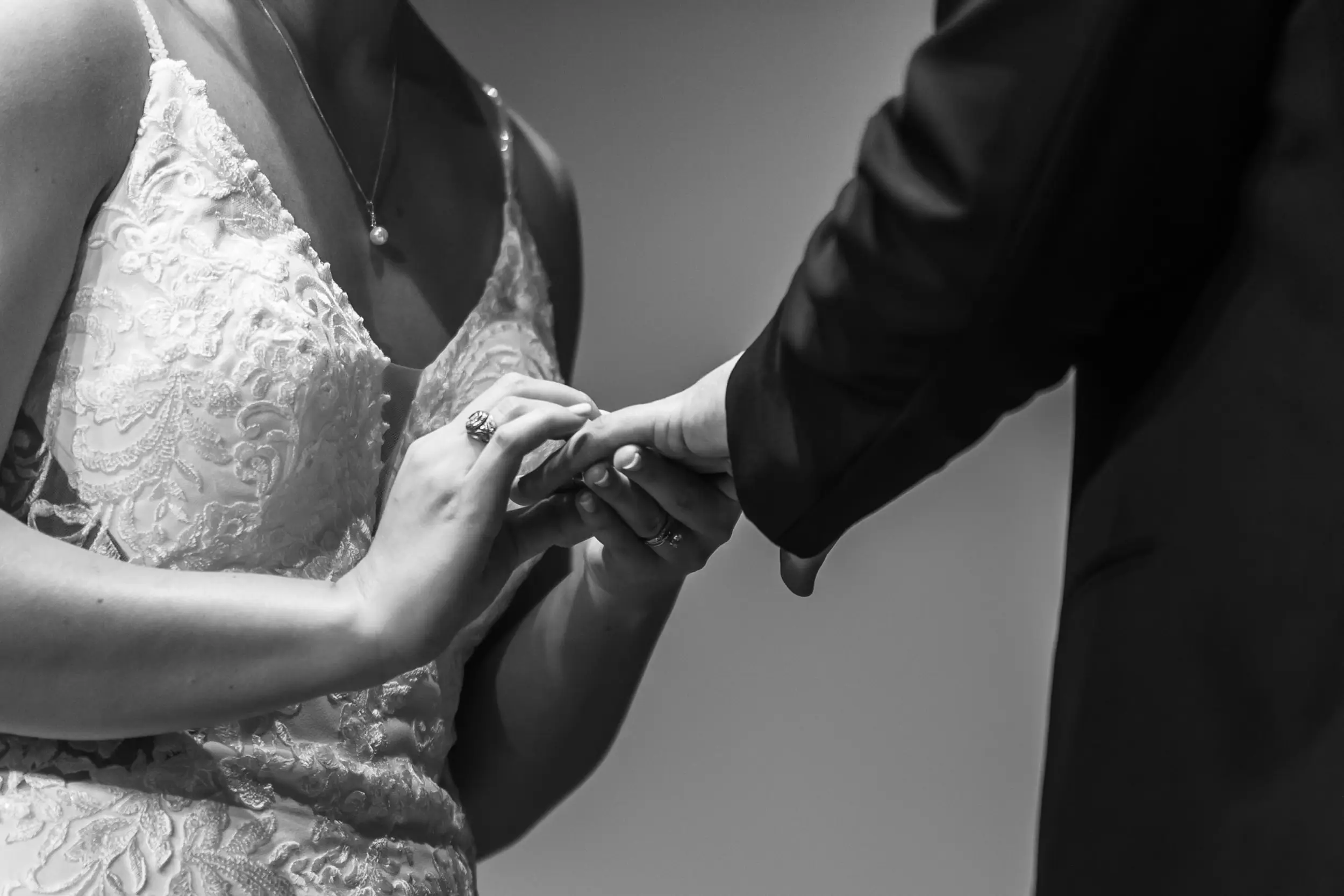 The bride puts a ring on the groom's finger during their YMCA of the Rockies wedding in Estes Park, Colorado.