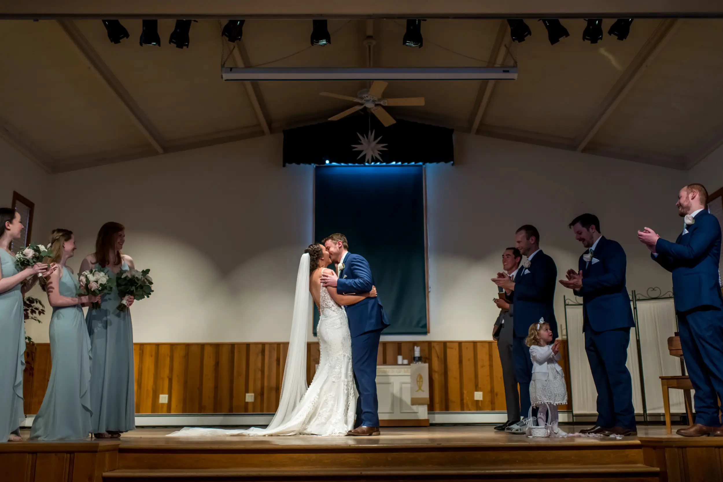 The bride and groom kiss during their YMCA of the Rockies wedding in Estes Park, Colorado.