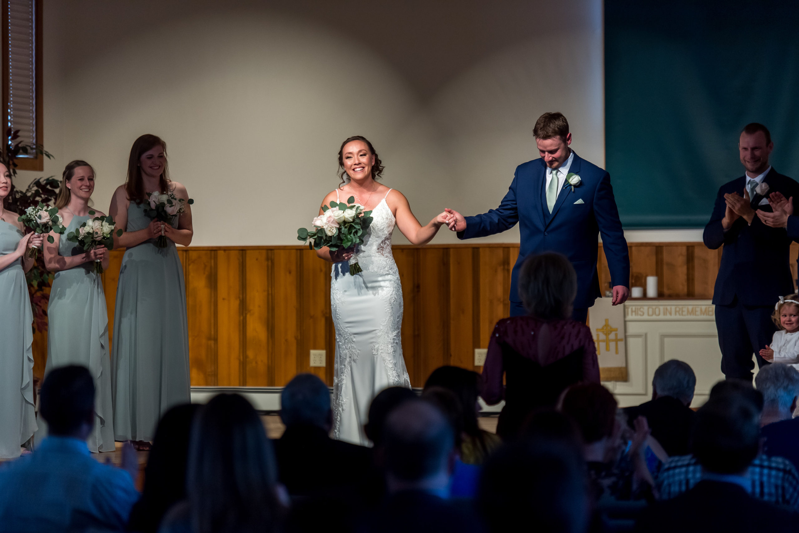 The bride and groom acknowledge guests during their YMCA of the Rockies wedding in Estes Park, Colorado.