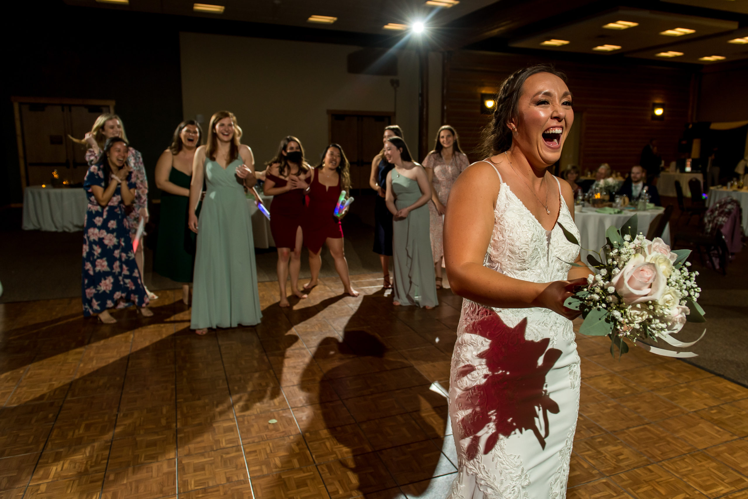 Bride prepares to throw the bouquet during a YMCA of the Rockies wedding in Estes Park, Colorado.