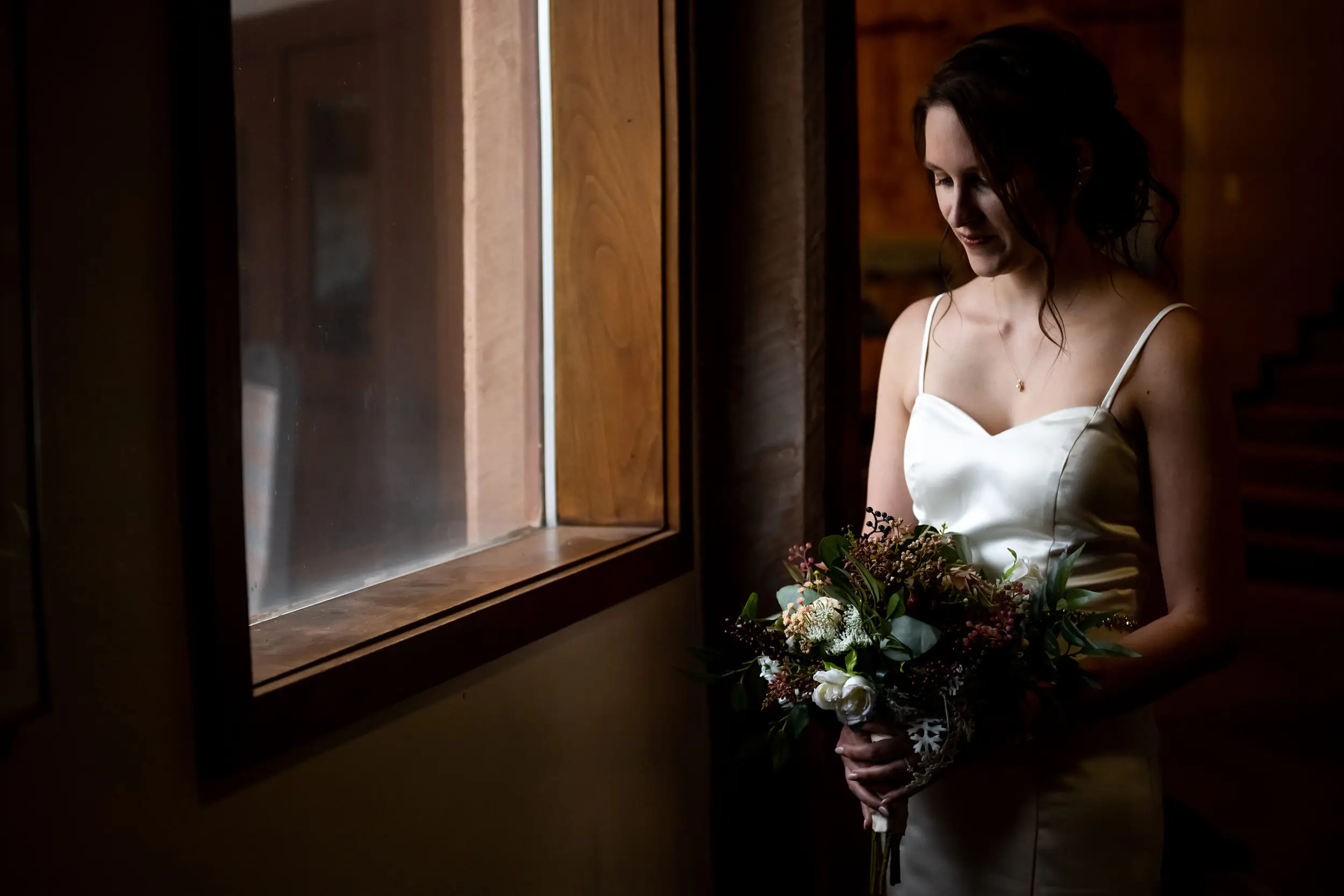 Liz poses before her Roxborough State Park wedding in the snow.