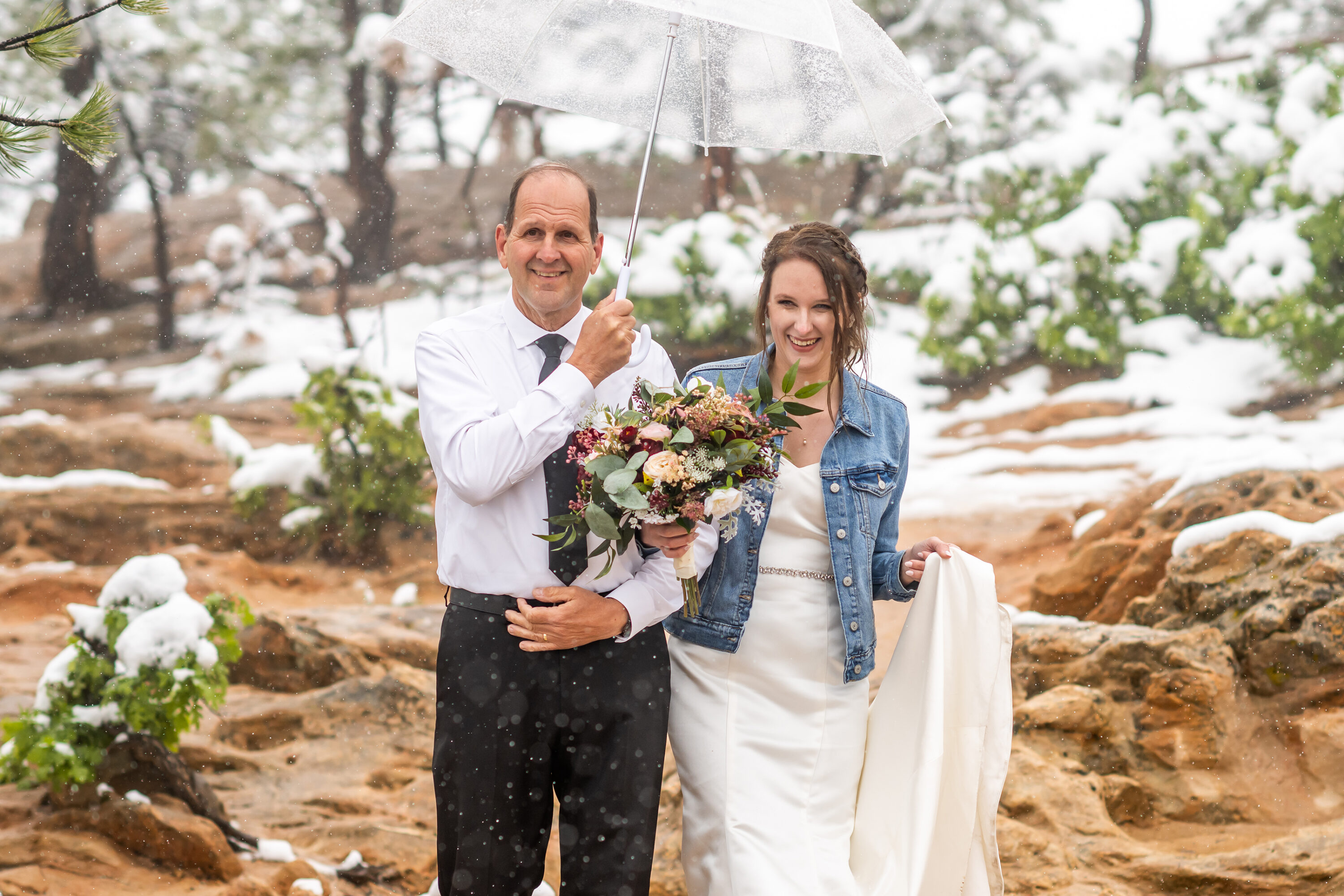 Liz walks down the aisle during her Roxborough State Park wedding at Lyons Overlook in the snow.