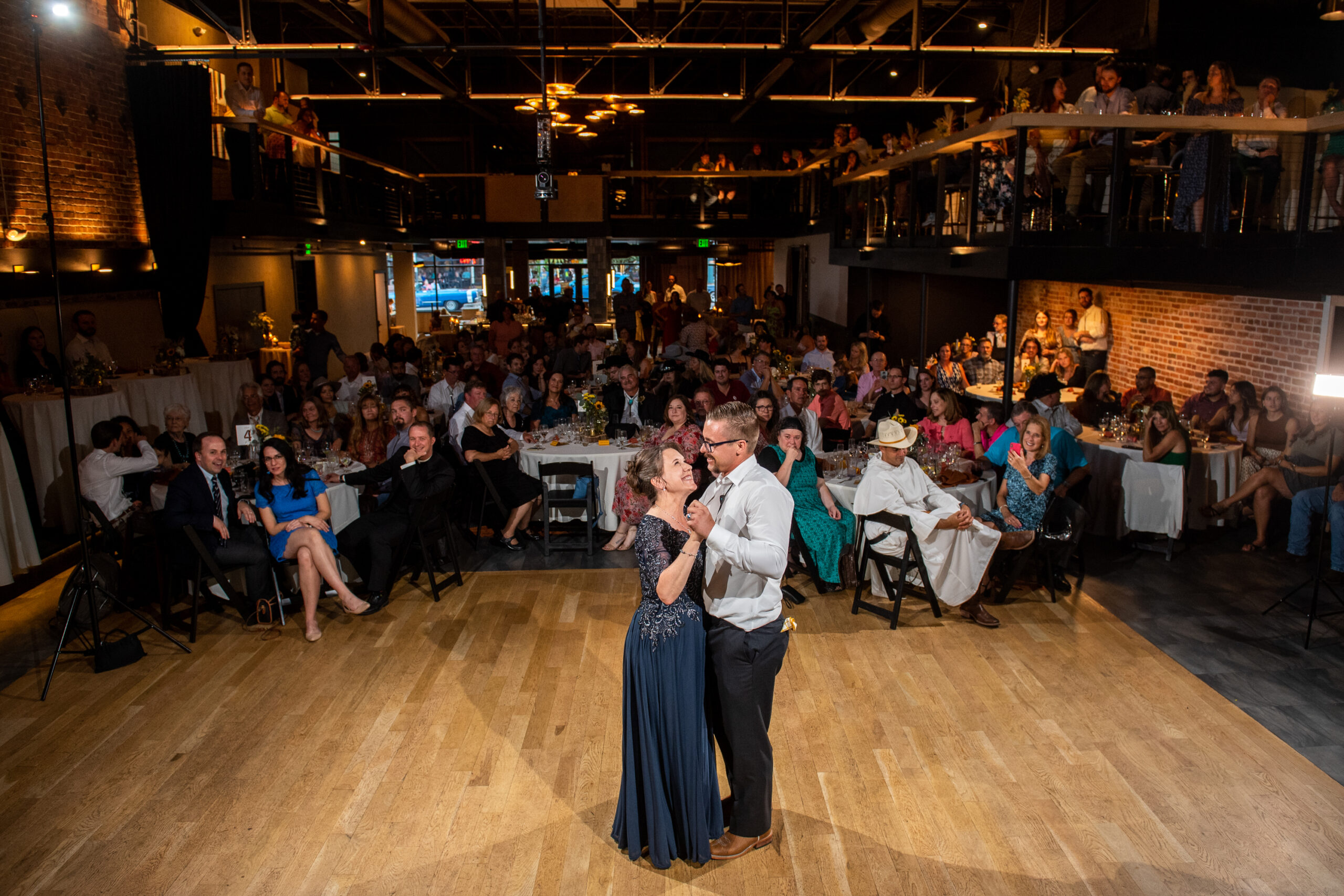 A groom and his mother dance solo during a wedding reception at the Rose Event Center in Golden, Colorado.
