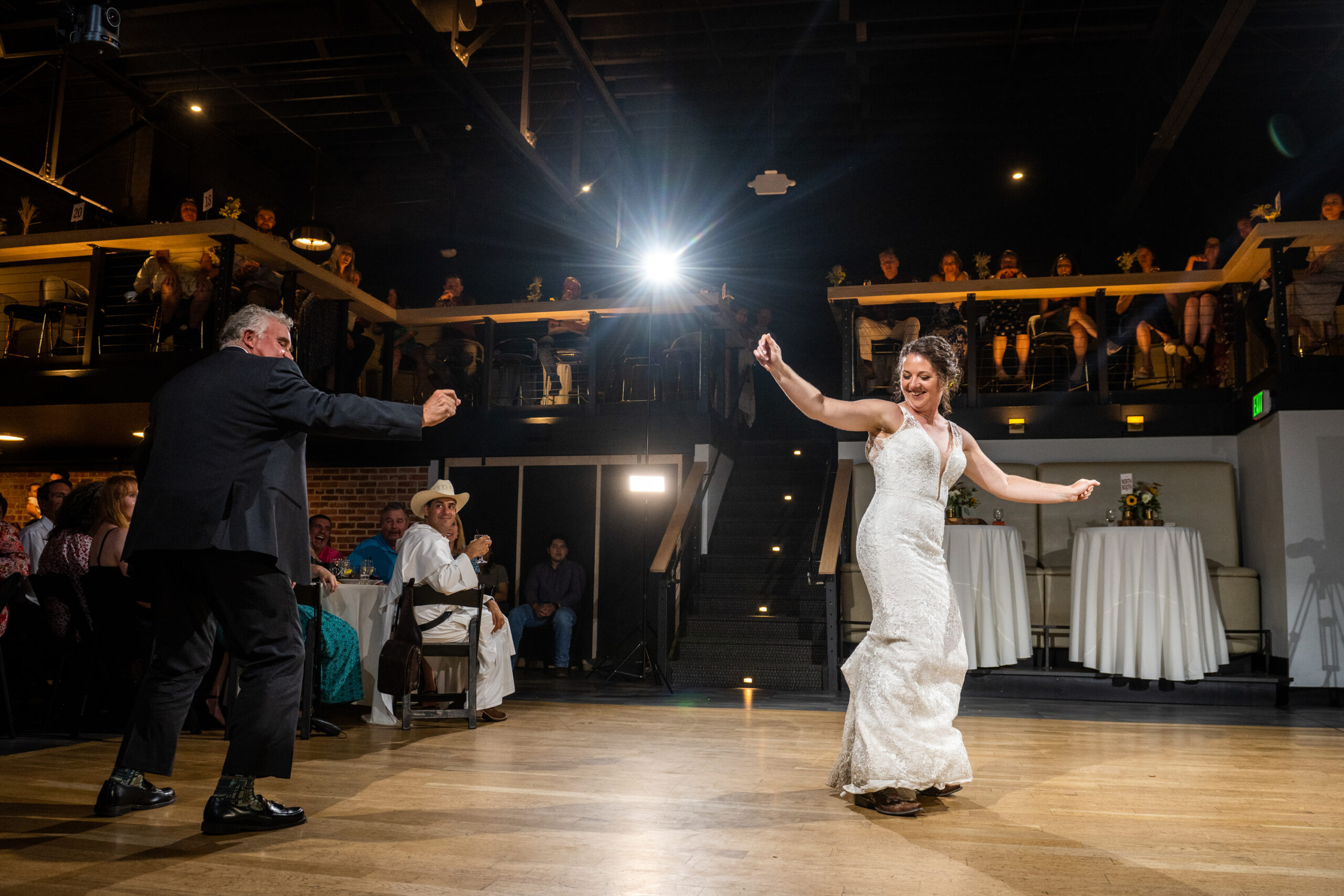A bride and her father perform their first dance during a wedding reception at the Rose Event Center in Golden, Colorado.
