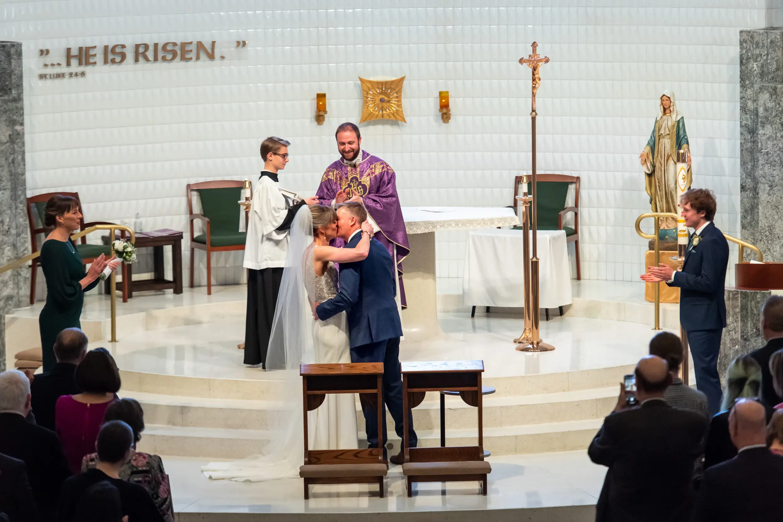 The bride and groom kiss after their Risen Christ Church Denver wedding in Denver, Colorado.
