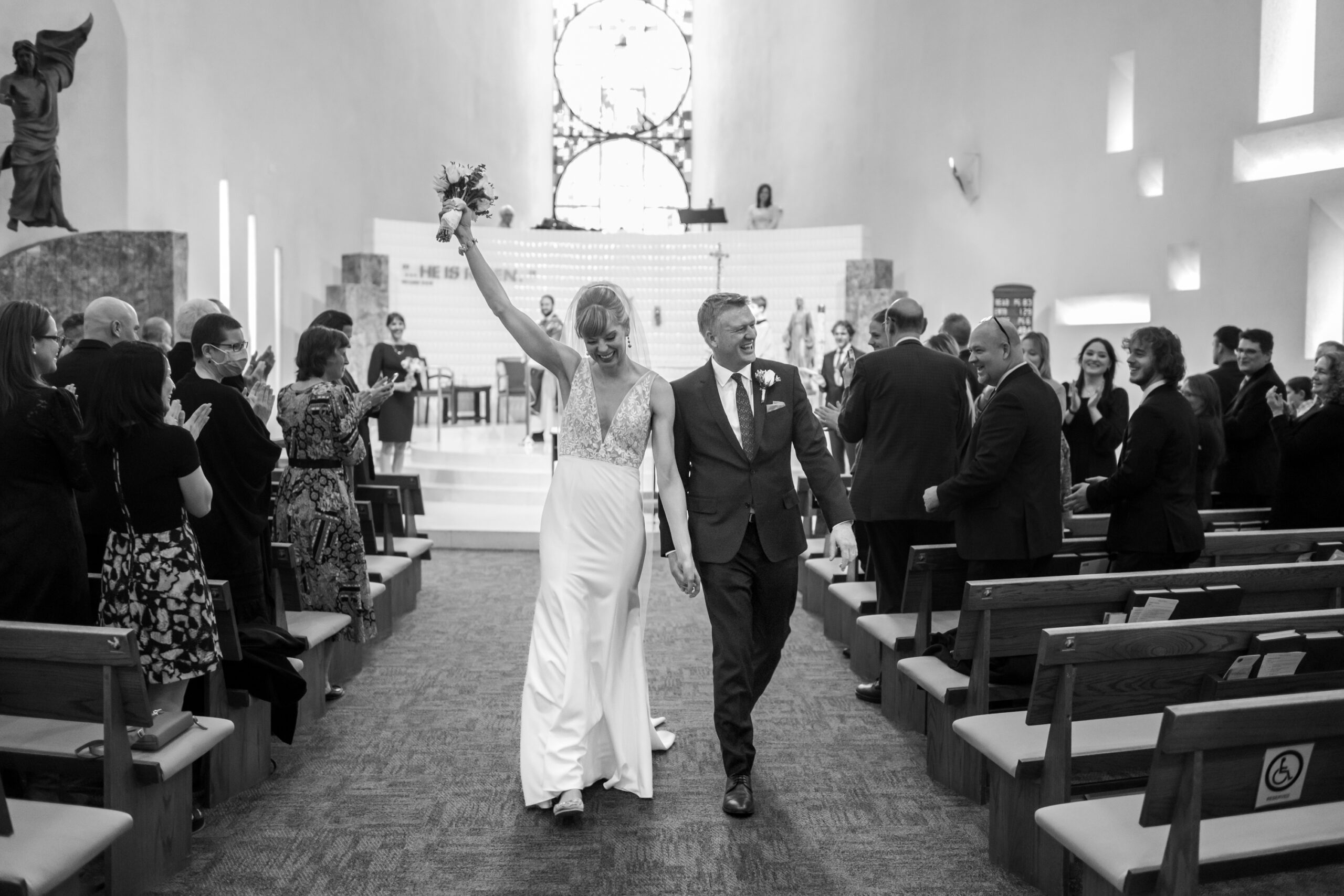 The bride and groom celebrate after their Risen Christ Church Denver wedding in Denver, Colorado.