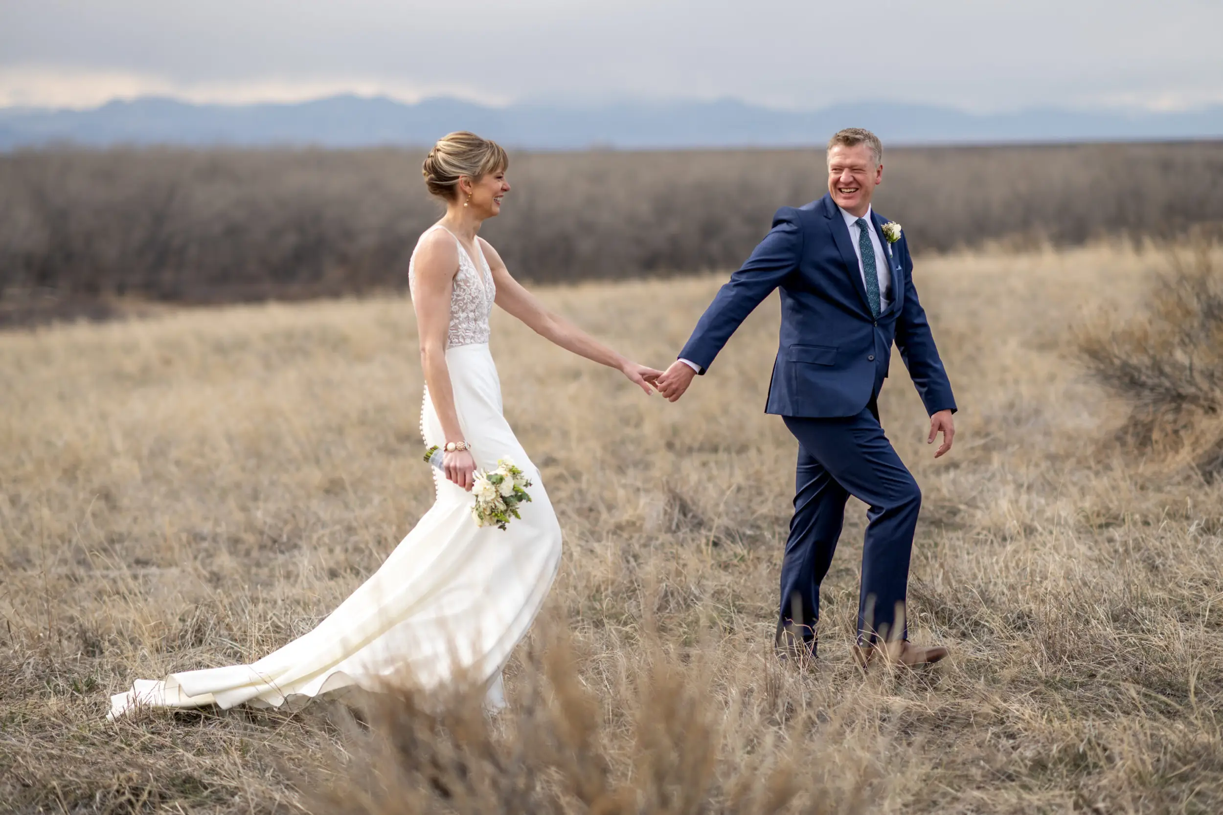 The bride and groom pose for couples photos at Cherry Creek State Park outside of Denver, Colorado.