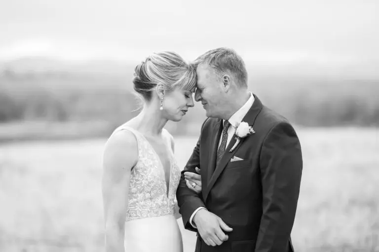 The bride and groom pose for couples photos at Cherry Creek State Park outside of Denver, Colorado.
