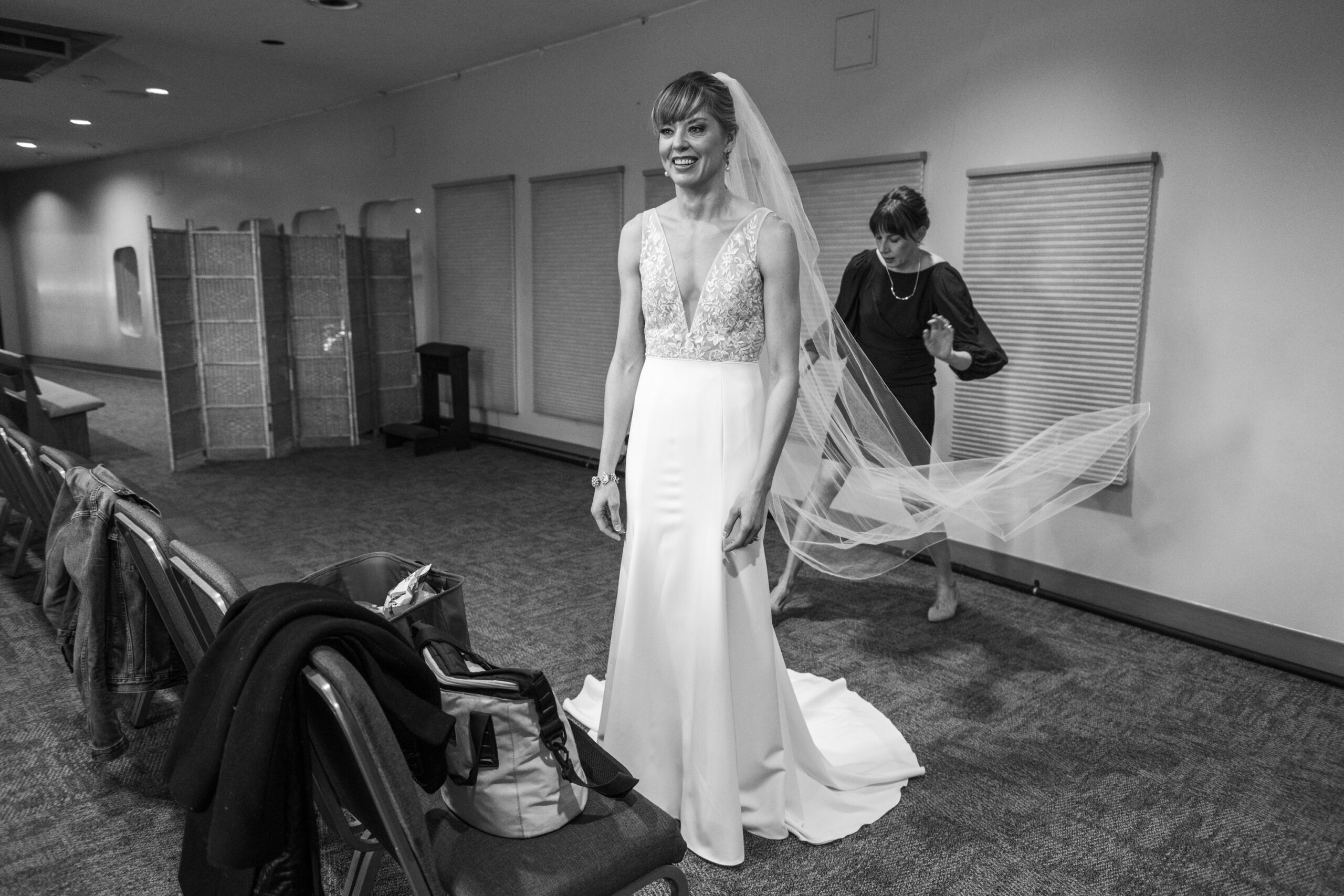 The bride does final preparation during her Risen Christ Church Denver wedding in Denver, Colorado.
