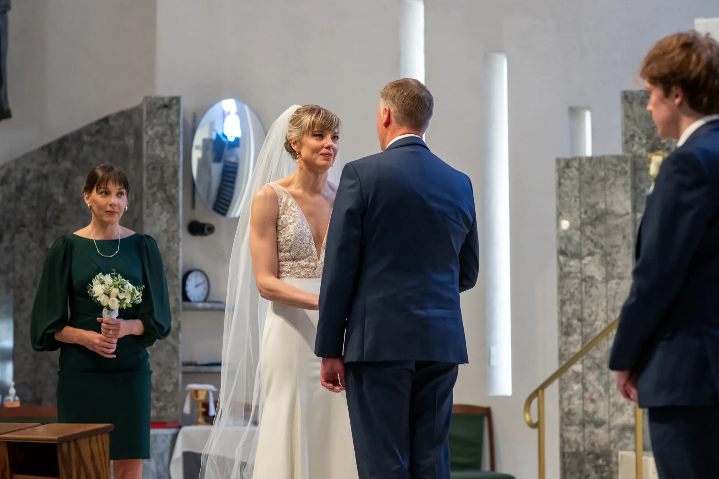 The bride and groom are married during their Risen Christ Church Denver wedding in Denver, Colorado.
