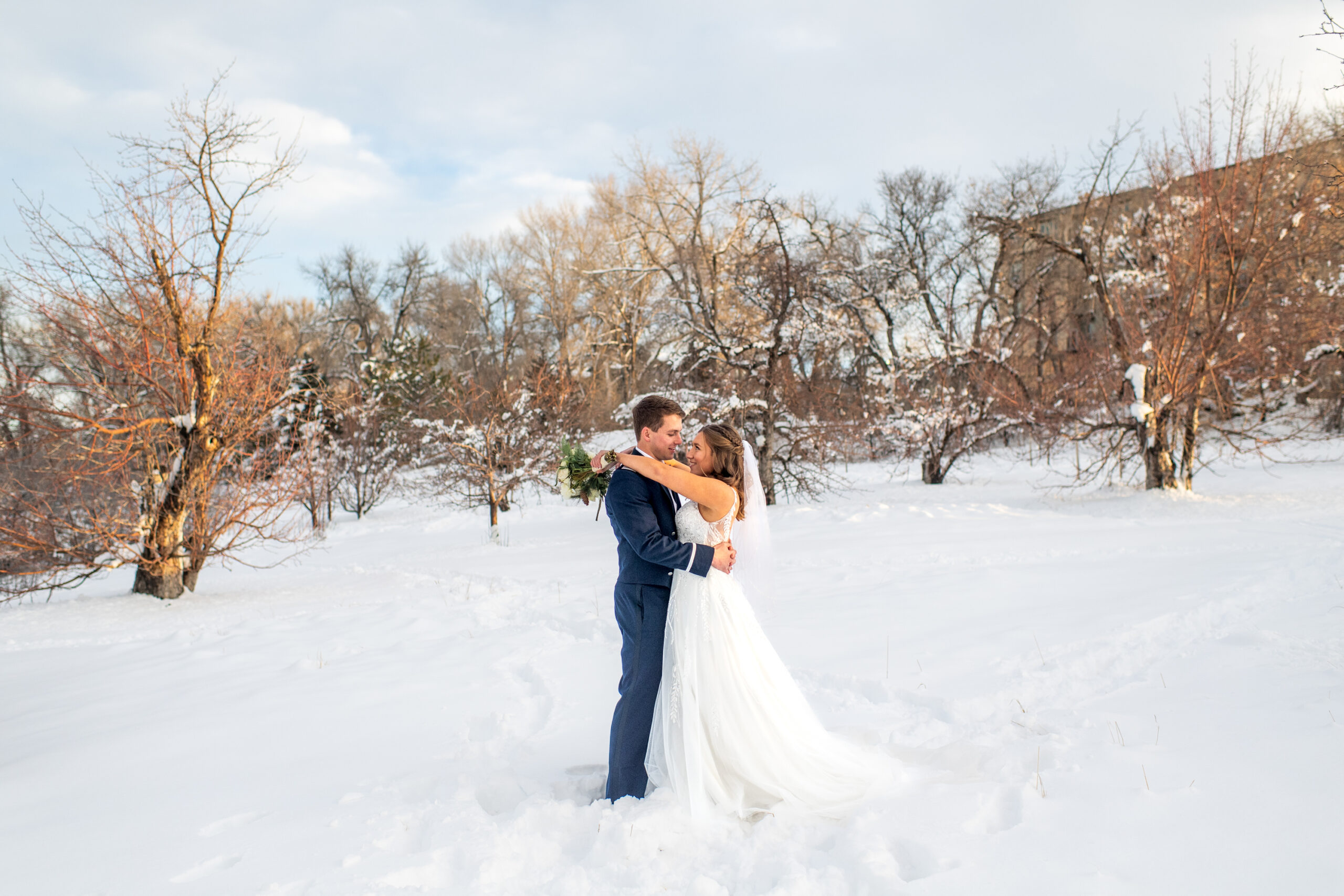 The bride and groom pose at Fly'n B Park in Littleton, Colorado, during their wedding at Ashley Ridge by Wedgewood Weddings.