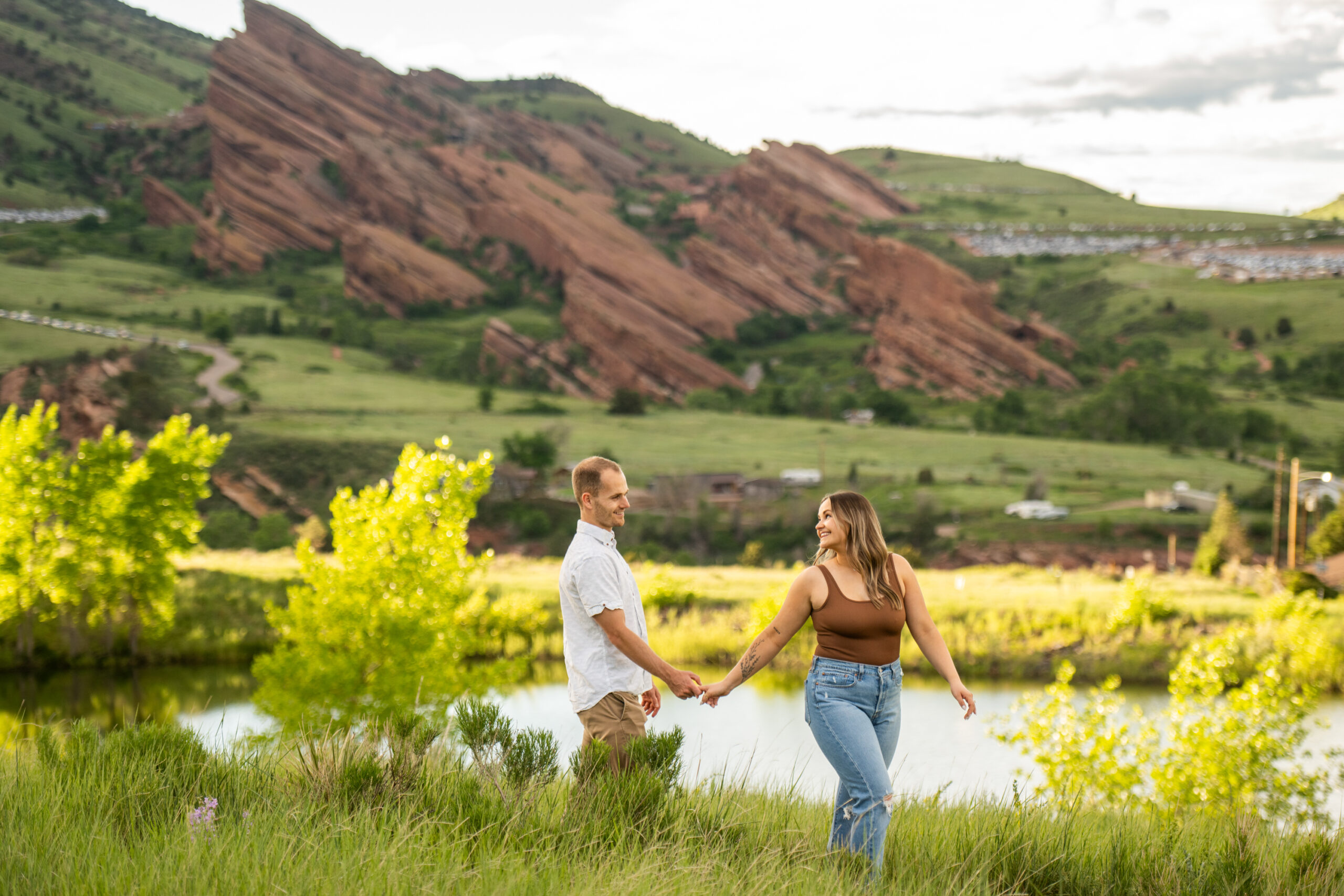 Ryan and Elizabeth walk hand-in-hand during a surprise proposal and engagement photos at Mt. Falcon Park East Trailhead near Denver, Colorado.