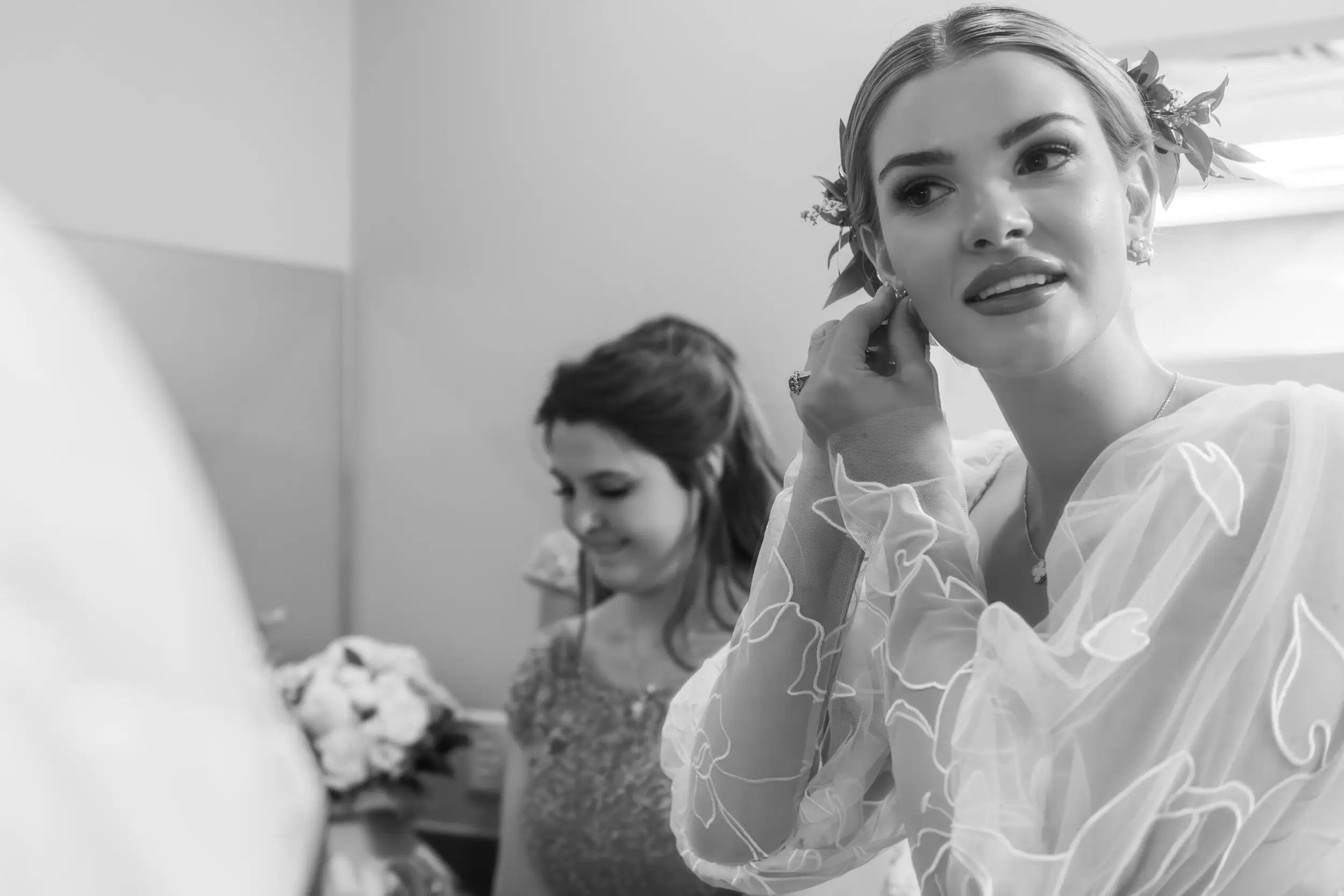 A bride puts on her earrings before her wedding at the cathedral basilica of the Immaculate Conception in Denver, Colorado.