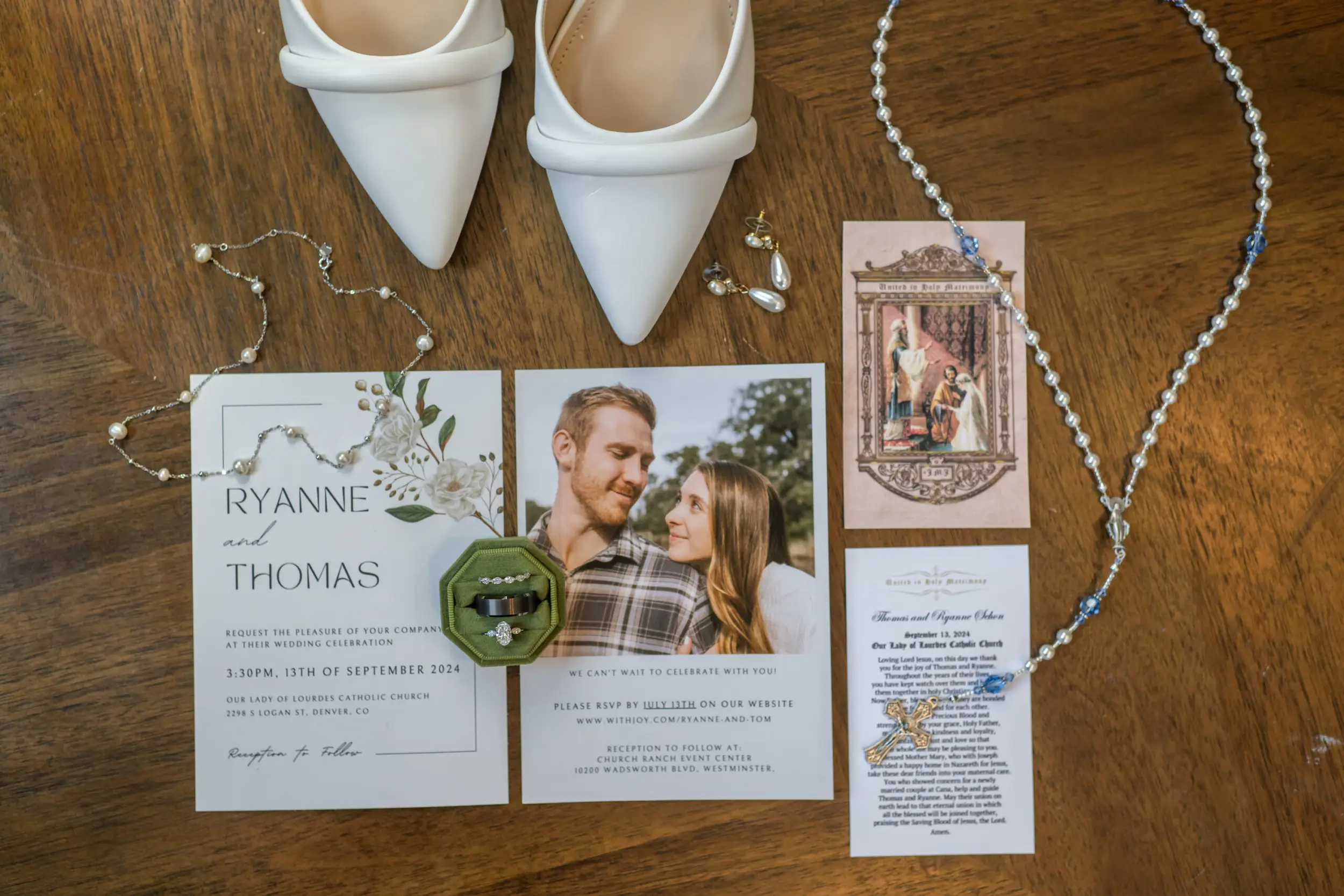 A lay flat showing the necklaces, earrings, rosary, prayer card and bride's shoes are seen before a wedding Mass at Our Lady of Lourdes Catholic Church in Denver, Colorado.