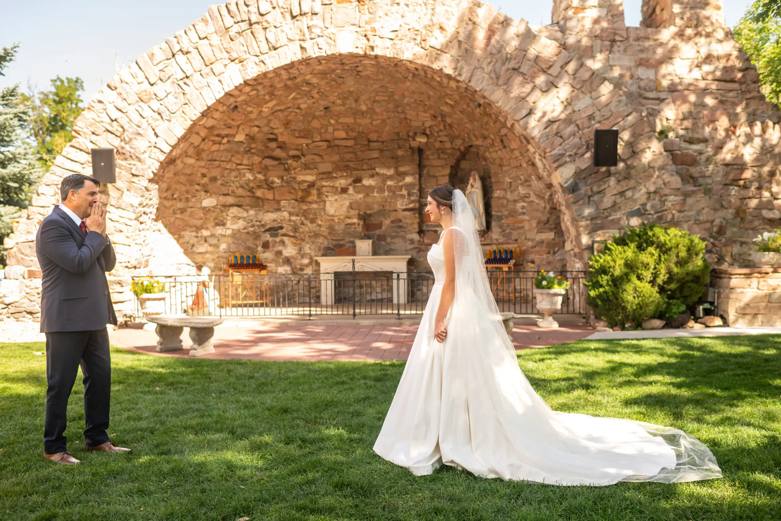 A father reacts to seeing his daughter in a wedding dress for the first time at Our Lady of Lourdes Catholic Church in Denver, Colorado.